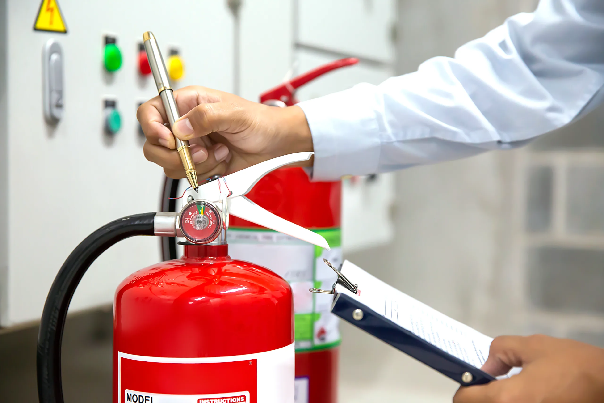 Technician inspecting and servicing a fire extinguisher
