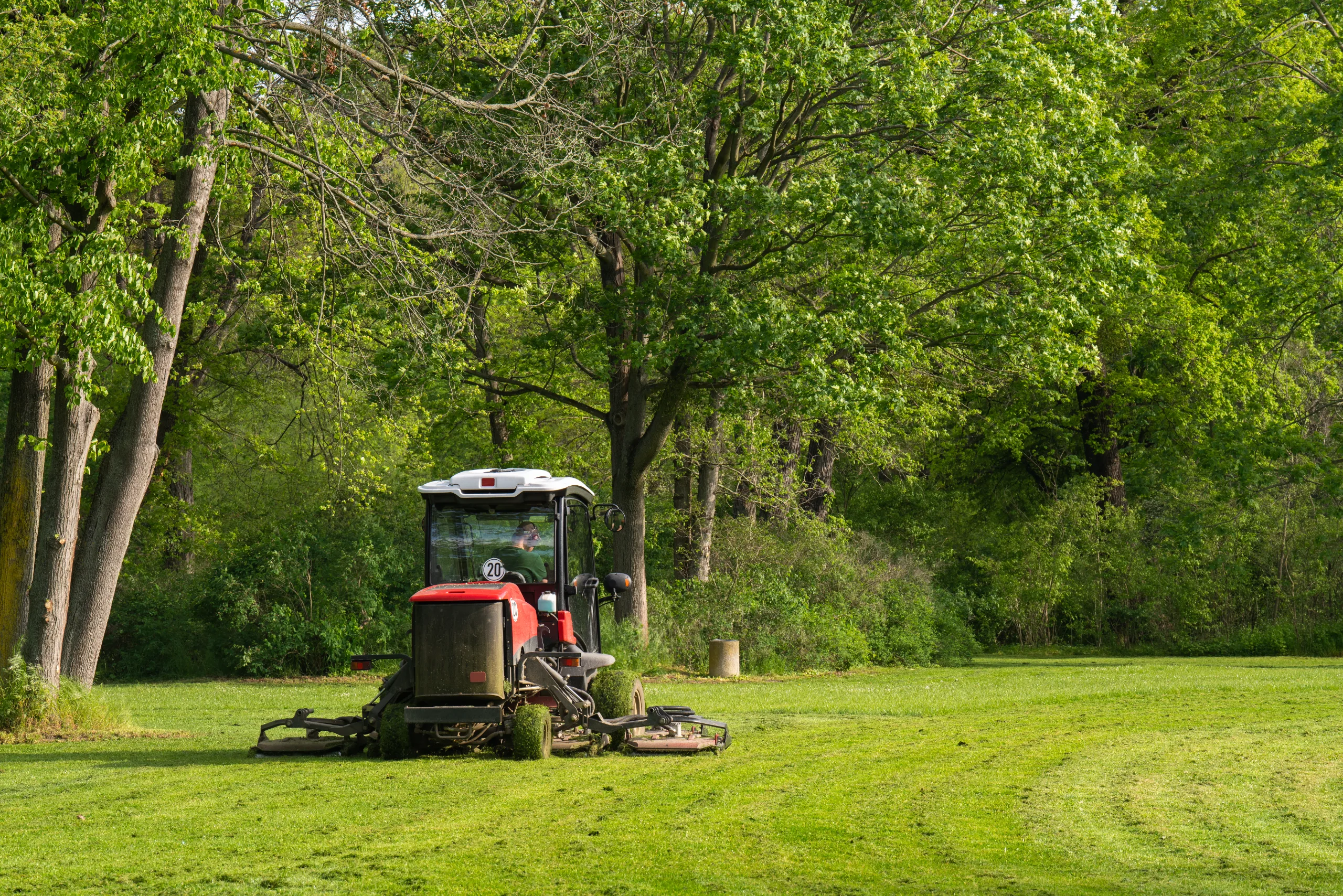 Commercial grounds maintenance using mowing equipment