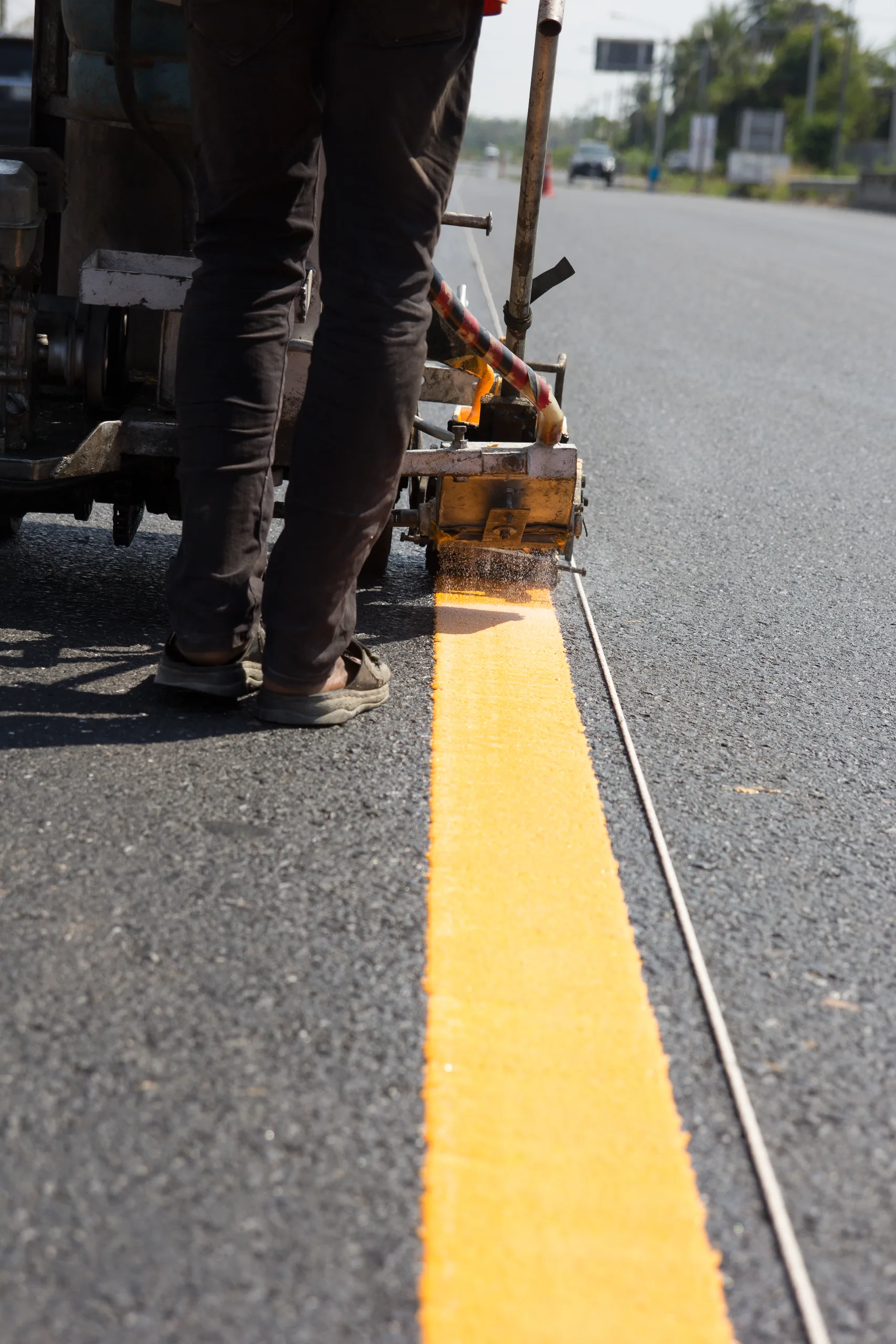 Worker applying parking-lot striping