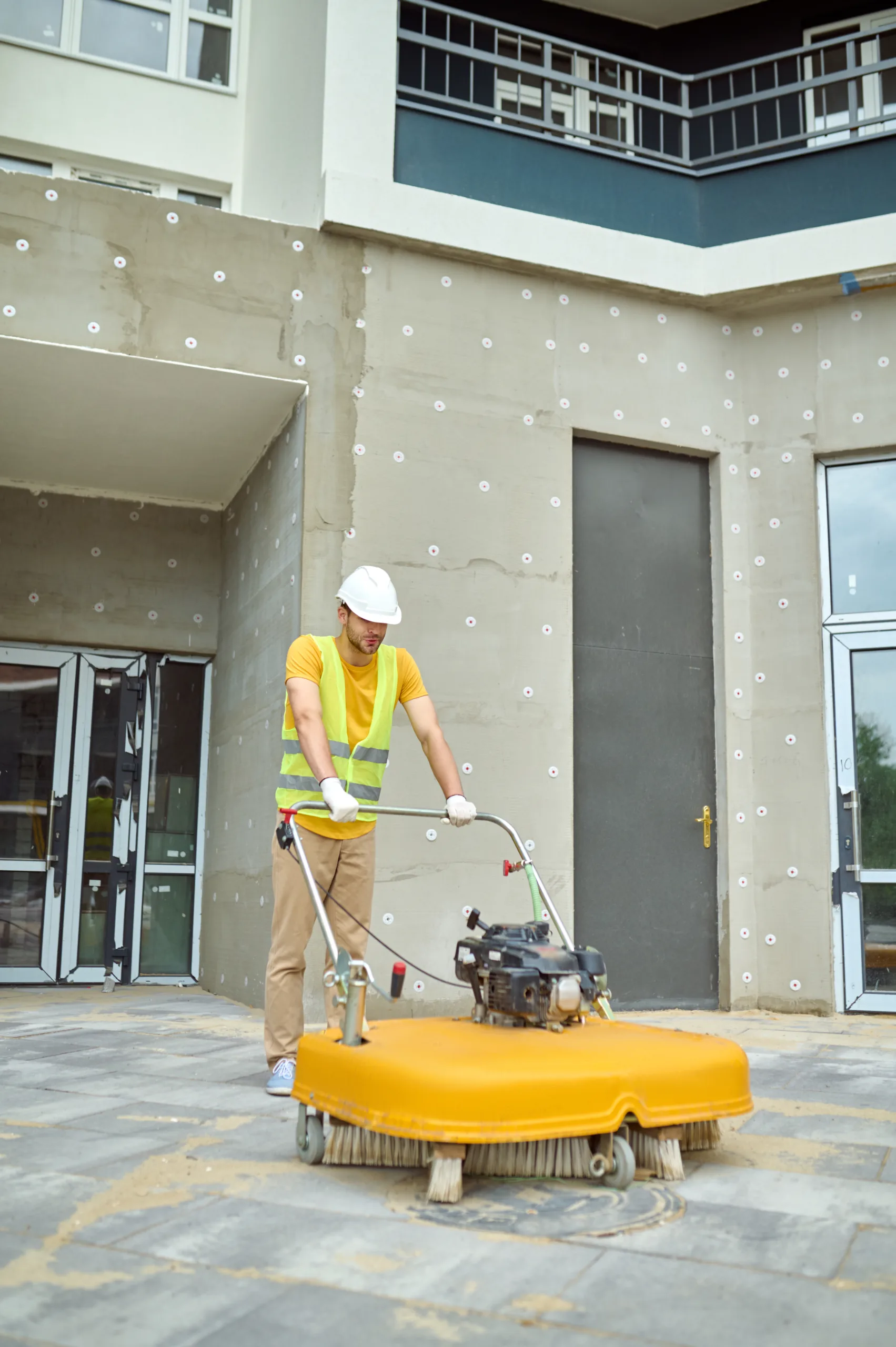 Sweeping equipment cleaning a paved exterior area