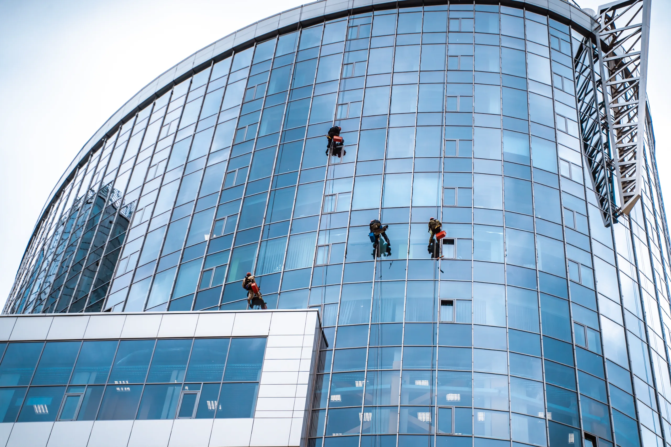 Workers cleaning windows on a commercial building